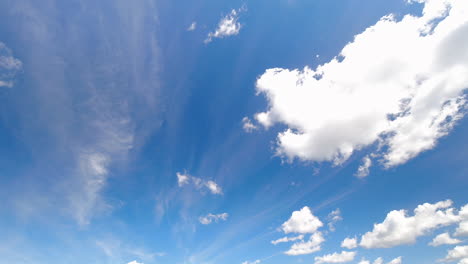 Timelapse-shot-of-white-puffy-clouds-moving-across-the-beautiful-blue-sky