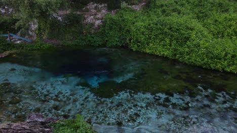 Drone-footage-of-the-clear-blue-water-of-Blue-Eye-Spring,-Albania