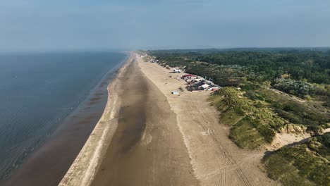 A-few-seaside-houses-on-a-beautiful,-quiet-beach-in-Rockanje-as-seen-from-above