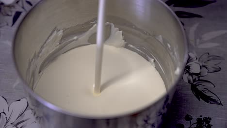 Fresh-Cream-Being-Poured-Into-Mixing-Tin