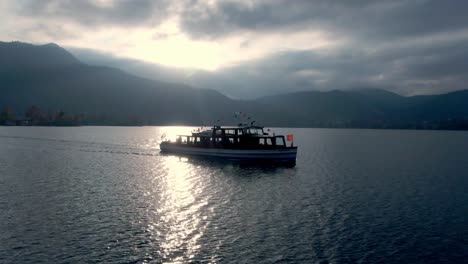 Cinematic-aerial-follow-of-ferries-in-a-german-lake-taken-during-sunset