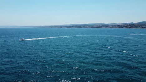 Aerial-drone-tracking-video-of-luxury-yacht-cruising-in-deep-blue-open-ocean-sea