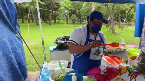Slow-motion-shot-of-a-traditional-mexican-cook-in-the-Chapultepec-forest-preparing-quesadillas