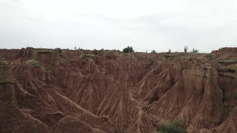 Flying-Over-Red-Clay-Canyons-On-Arid-Tatacoa-Desert-In-Colombia