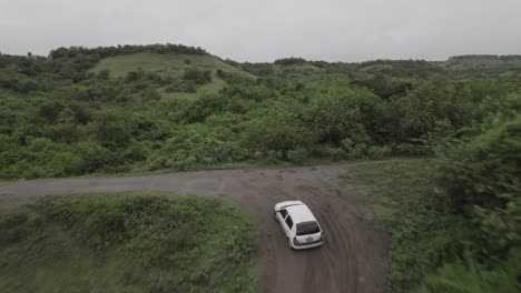 Aerial-Following-Vehicle-Driving-On-Dirt-Road-In-Tropical-Mountains-Of-Colombia