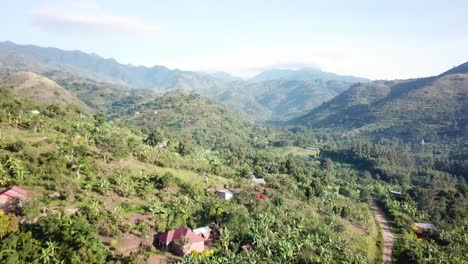Aerial-scenic-view-of-Rwenzori-Mountains-and-rural-area-in-Uganda,-Africa