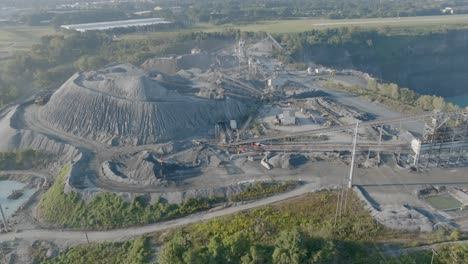 Wide-aerial-footage-of-a-quarry-operation-in-the-early-morning-in-Kennesaw,-Georgia