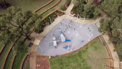 Aerial-Ascending-View-Over-Round-Playground,-Las-Ramblas-Park,-Clarkson,-Perth