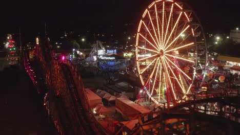 Classic-Coaster-And-Grand-Wheel-At-Washington-State-Fair-At-Night-In-Puyallup,-Washington,-USA