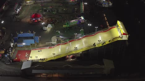 People-Sliding-On-A-Giant-Slide-At-Night-At-Washington-State-Fair-In-Puyallup,-USA