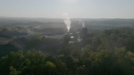 Wide-aerial-footage-of-a-smokestack-in-the-early-morning-in-Kennesaw,-Georgia