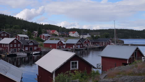 Panning-view-of-typical-Nordic-village-with-red-houses-at-the-sea