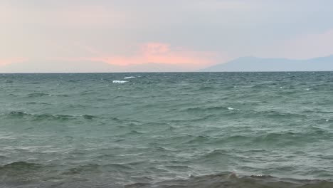 Windy-sea-and-waves-with-mountain-view-pastel-background