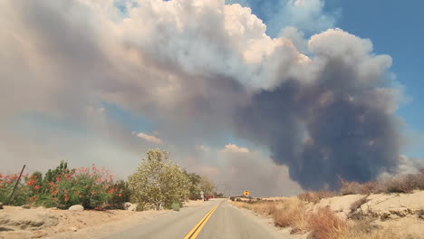 Pov-shot,-car-driving-Along-countryside-road-towards-Smoke-plumes-from-California-Fires