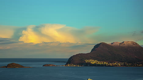 Timelapse-shot-of-illuminated-cloud-bank-at-sunrise-moving-right-over-horizon-with-boat-traffic-in-fjord-in-foreground---Alesund,-Norway
