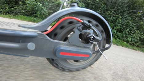 POV-Shot-From-The-Back-Wheel-While-Riding-An-Electric-Scooter