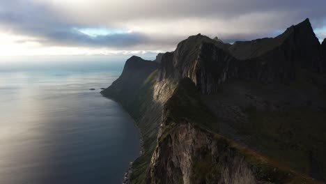 Cinematic-aerial-view-of-Fjord-and-mountain-cliffs-in-Arctic-Norway,-Senja