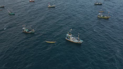 Aerial-Drone-Shot-of-Anchored-Fishing-Boats-Out-at-Sea