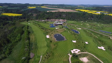 Golf-courses-and-ponds-near-Kacov-in-Czech-Republic,-popular-golfing-area,-panoramic-aerial-drone-view