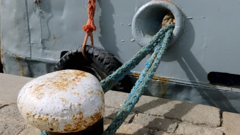 Close-up-ship-bow-hawser-rope-on-strong-mooring-bollard-Sozopol-harbour