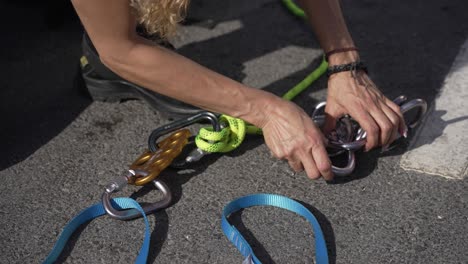 Firefighter-attaching-carabiner-to-rope-in-training-exercise