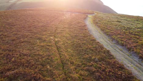 Aerial-Drone-Footage-Revealing-Sunset-Over-Coast-Path-and-Rolling-Fields-in-North-Devon-UK-4K