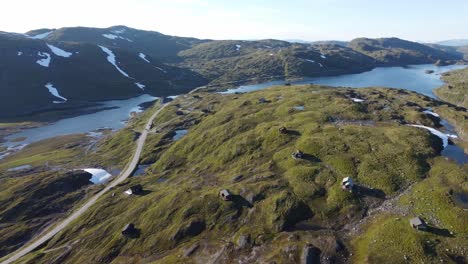 Beautiful-aerial-view-from-top-of-mountain-Vikafjell---Huts-and-leisure-homes-in-majestic-landscape-and-road-rv13-passing-beside-freshawater-lake-skjelingavatnet