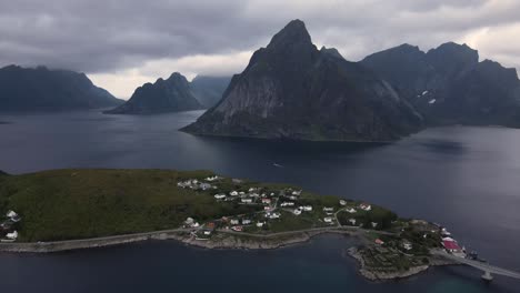 Peninsular-village-amongst-mountain-peaks-and-fjords-in-dark-water