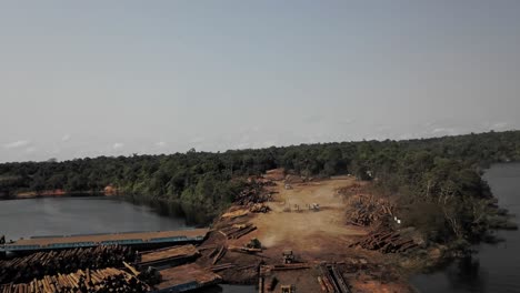 Harvesting-trees-in-the-Amazon-rainforest,-pull-back-aerial-view---concept:-deforestation,-environment,-exploitation,-climate-change