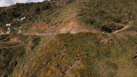 Aerial-push-out-shot-of-road-on-a-cliff-near-the-shore