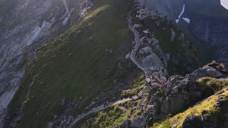 Epic-view-of-hiking-tourists-trekking-up-steep-stairs-on-Reinebringen-ridge