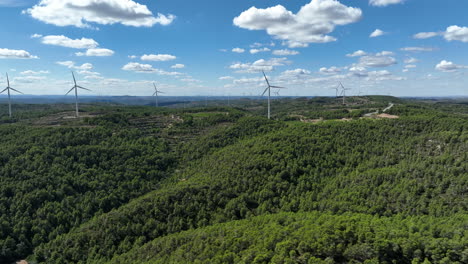 Prores-footage-of-wind-turbine-for-eolic-energy-production-on-green-mountain-of-Coll-de-Moro,-Catalonia-in-Spain