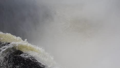 High-angle-static-shot-of-water-falling-from-cascade-generating-water-vapor