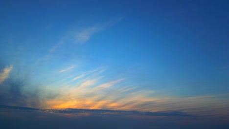 Panoramic-fiery-golden-cirrus-clouds-on-blue-gradient-sky