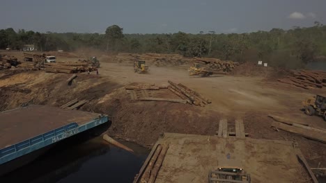 Deforestation-by-large-logging-operations-in-Brazil's-Amazon-rainforest---aerial-flyover-of-a-dock-on-the-Tocantins-River