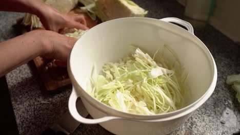 Finely-Chopped-Cabbage-For-Making-Sauerkraut-Placing-In-A-Big-White-Bowl