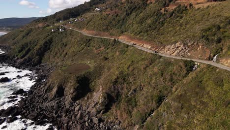 Aerial-view-of-highway-on-a-cliff-near-the-rocky-shoreline-in-Chile