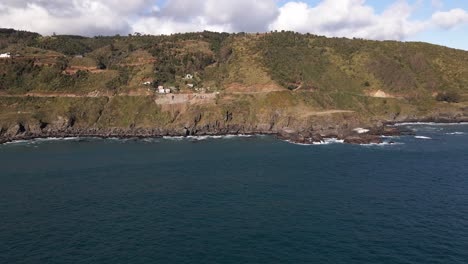 Aerial-circing-shot-of-the-coastline-in-a-cliffside-taken-during-the-day-in-Chile