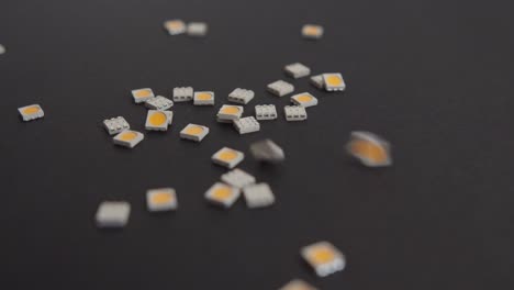 Dropping-Small-Electronic-Components-on-Black-Background