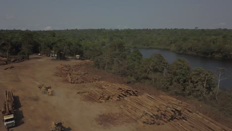 Stacks-of-logs-from-trees-cut-down-in-the-Amazon-rainforest---aerial-view
