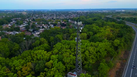 Orbital-aerial-view-of-cell-phone-tower-close-to-neighbourhood