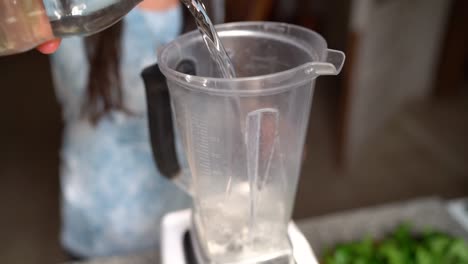 A-Person-Pouring-Water-Inside-The-Blender
