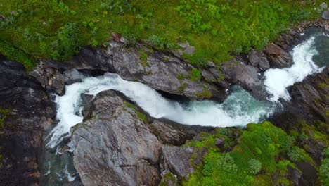 Clean-mountain-river-Sendedalselva-at-Vikafjellet-mountain-in-Norway---Closeup-birdseye-aerial-looking-down-at-crisp-river-water-flowing-down-rocky-mountainside---Vikafjell-Myrkdalen-western-Norway