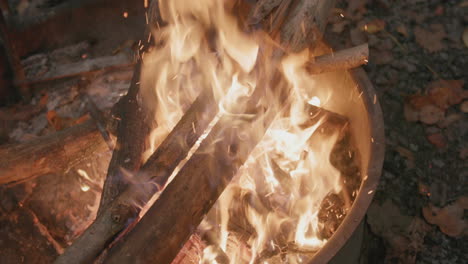 Close-slow-motion-footage-of-a-fire-in-a-fire-ring-at-a-campground