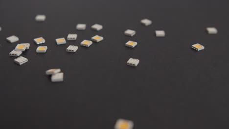 Dropping-Small-Electronic-Components-on-Black-Background-1