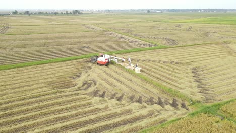 Aerial-Drone-Shot-of-Combine-Harvester-Offloading--Grain