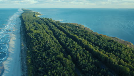 Aerial-view-above-long-stretching-green-island-forest-landscape-on-the-Baltic-sea,-Poland