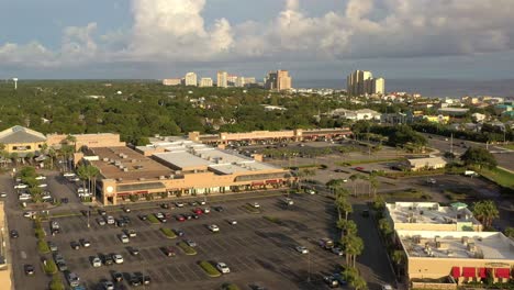 Drone-view-flying-over-Silver-Sands-Outlet-Mall-in-Destin-Florida-with-a-view-of-the-Gulf-of-Mexico