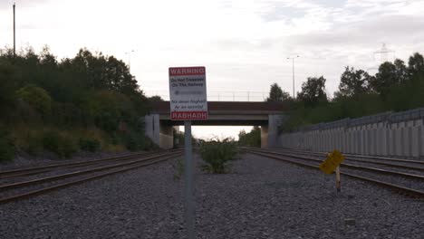 Timelapse-Of-Irish-Rail-Trains-Traveling-Through-The-Railroads-With-Do-Not-Trespass-On-The-Railway-Warning-Sign
