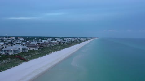 Drone-view-flying-from-the-beach-over-the-Gulf-of-Mexico-looking-towards-Rosemary-Florida-during-golden-hour-sunset